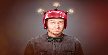 Man with red helmet on with three lightbulbs eliminated to show genius