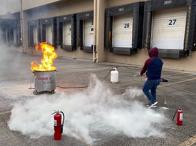 Man using fire extinguisher during Code 3 Safety & Training Fire extinguisher training