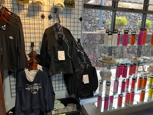 clothing displayed in the dive shop and colorful water bottles