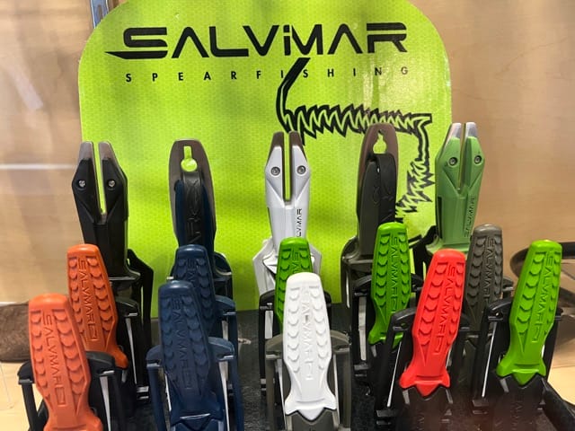 knives in a glass cabinet displayed inside a dive shop