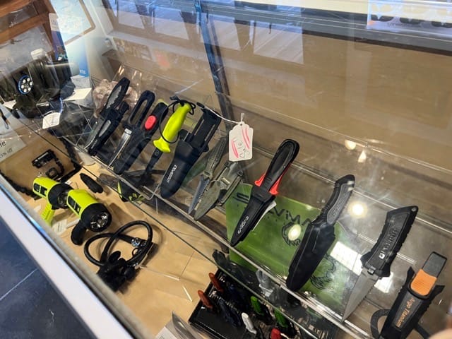 knives on display inside a dive shop