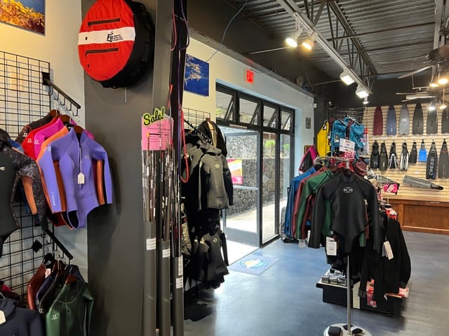 wetsuits and other products on display in a dive shop
