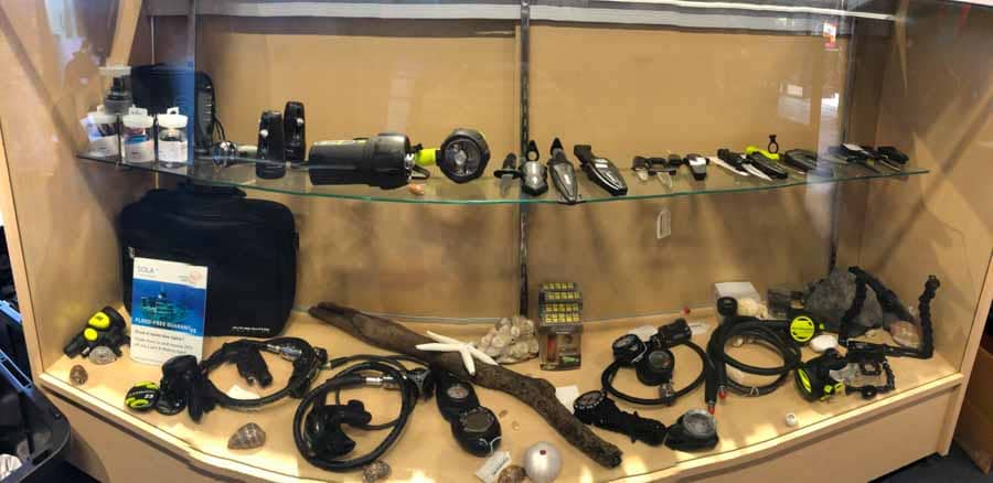 dive shop cabinet with knives and scuba regulators