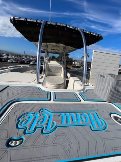 bow deck of a dive boat with neoprene floor pads and the word Honu Lele