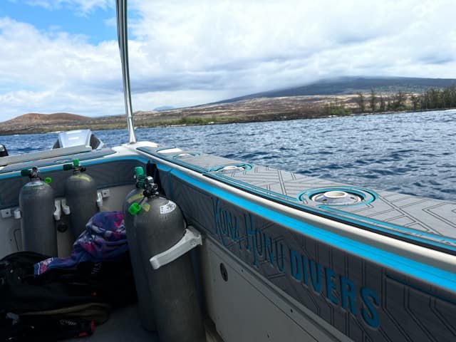 looking out over the gunwale of a boat at the big island of Hawaii