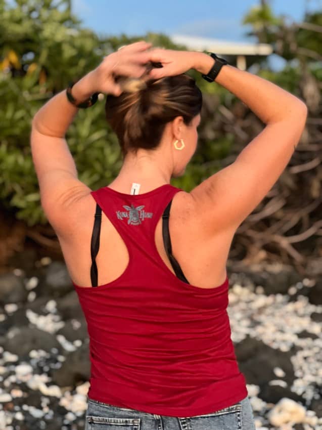 woman in a red tank top with Kona Honu Divers logo on back