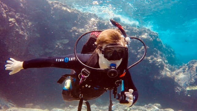 diver swims toward camera
