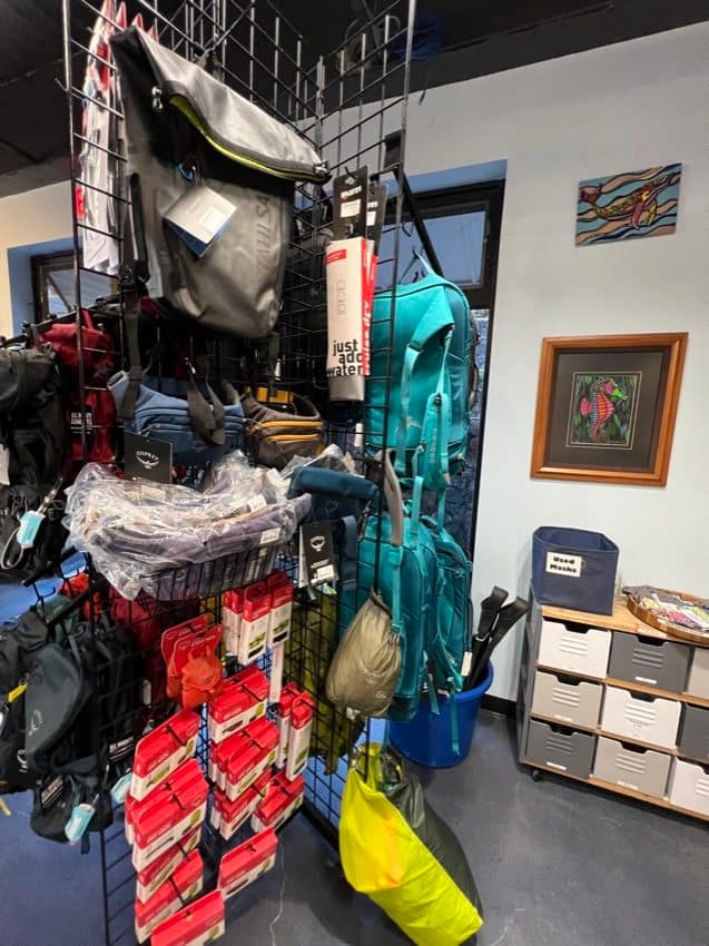 bags hanging on display in a dive shop