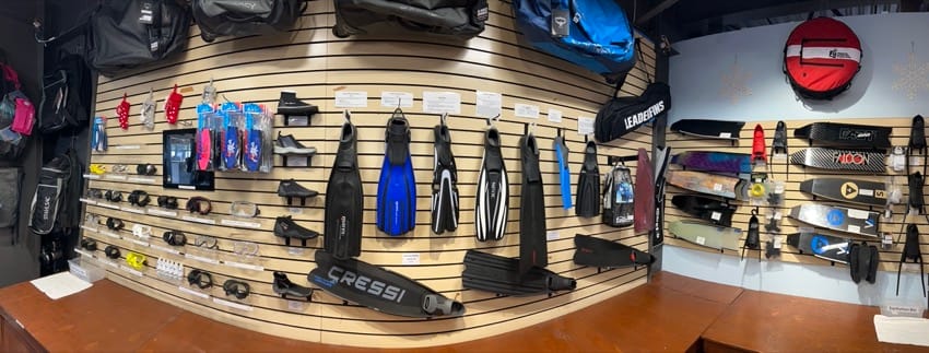 Wall of fins on display in dive shop