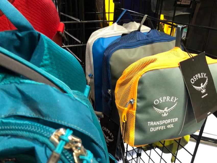 osprey bags on dive shop display grid wall