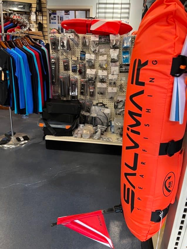 inside of dive shop with displays with floats and camera accessories