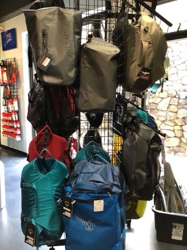 osprey bags hanging from a grid wall display
