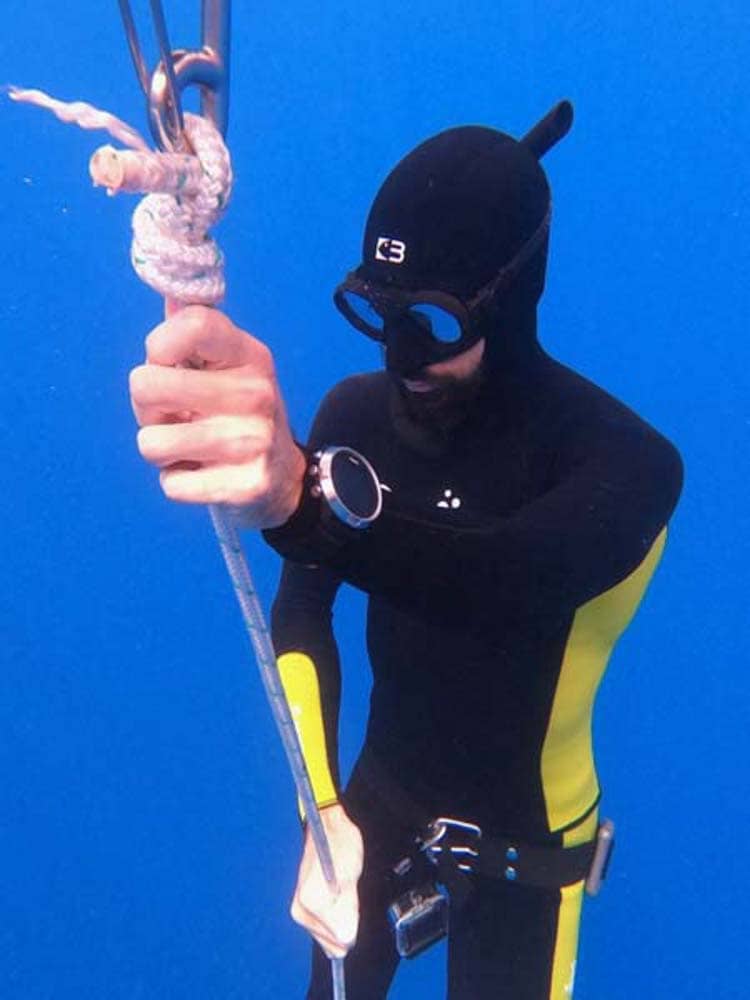 diver ascending line in custom freediving suit