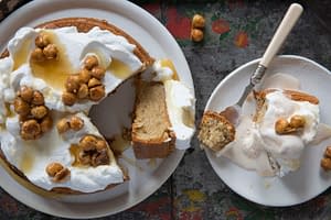 Hazelnut cake with caramelized hazelnuts served on white plates from Boqueria Spanish tapas restaurant in NYC.