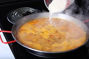 Step 5 - Add 1 cup Bomba rice. Cook for 5 minutes on high, then 5 minutes on low.