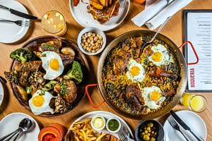 Spanish food featuring chicken paella, mimosas, and more from Boqueria for Memorial Day Weekend brunch specials.