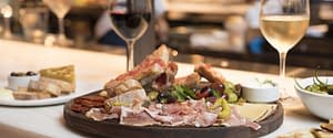 Spanish charcuterie & cheeses served with red and white wine at Boqueria Spanish tapas bar.
