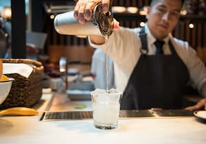 A bartender pouring a newly mixed drink out of his shaker at Boqueria West 40th Street.