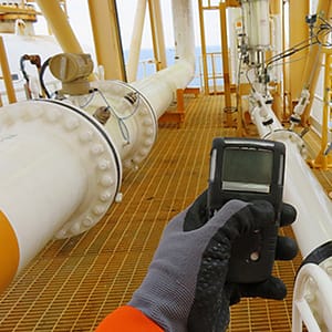 Employee testing air for gas