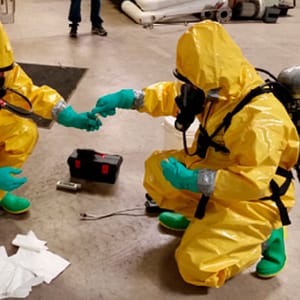 Hazmat crew testing unknown chemicals during training course