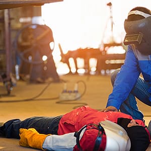 Welder treating coworker with CPR