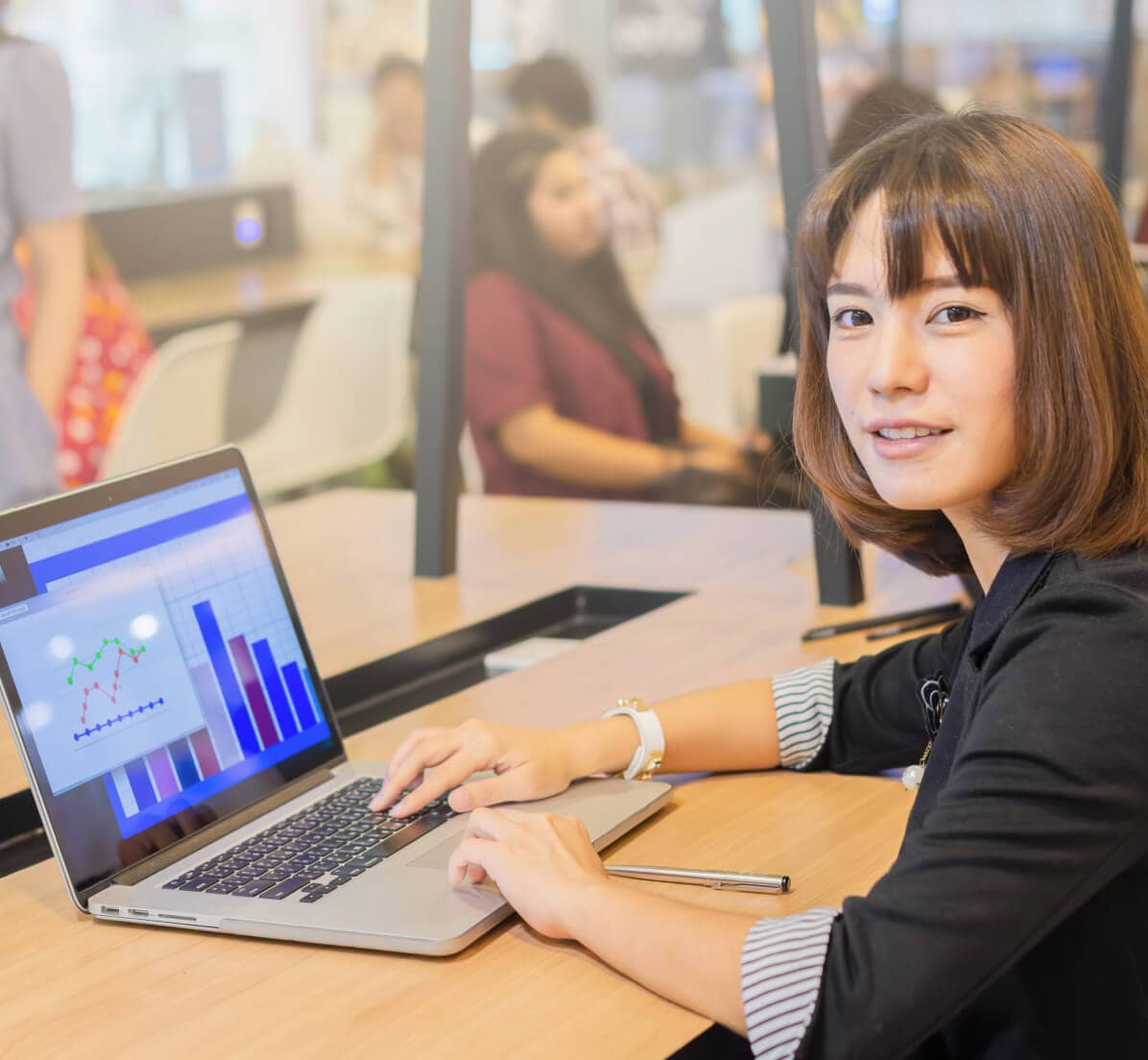 Woman in front of laptop looking at camera
