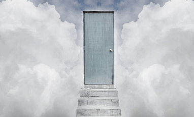 Cement stairs leading to a gray door with clouds on either side