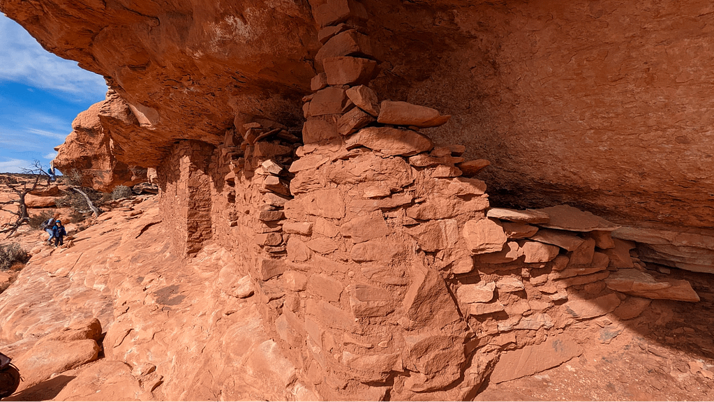 Rocks piled up around a broken portion of the wall.