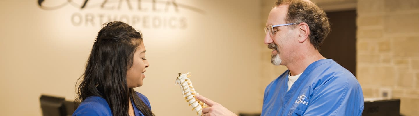 Orthopedic spine specialists discussing a patient treatment at Azalea Orthopedics.