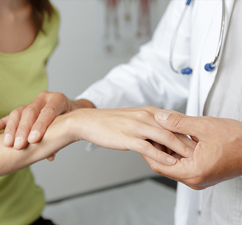 Orthopedic doctor examining a patient’s wrist for carpal tunnel syndrome in Pittsburg, Texas.