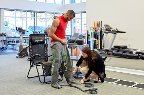 Patient receiving physical rehab therapy from an orthopedic doctor at Azalea Orthopedics.