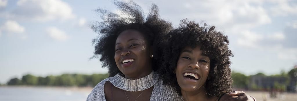 Two women smiling on the beach