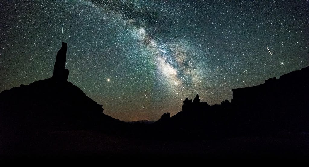 The starry Milky Way visible over a silhouette formation of Valley of the Gods, Bears Ears National Monument.