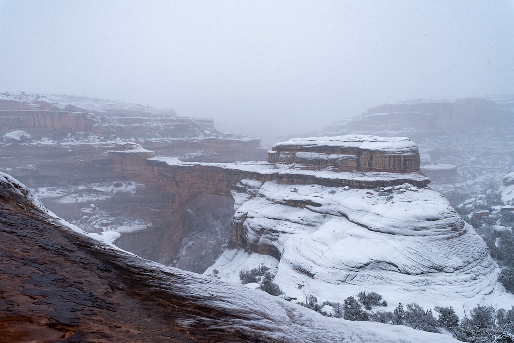 Snow on the red rock landscape of Natural Bridges