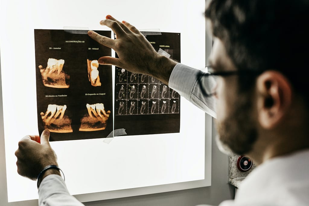 Dentist looking for signs of dental trauma to a loose adult tooth.