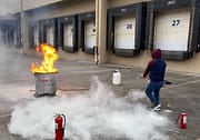 Man using fire extinguisher during Code 3 Safety & Training Fire extinguisher training