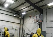 Men in Hazmat suits playing basketball