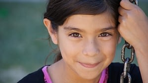 close-up of a young girl on a swing