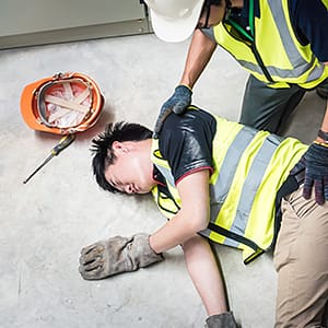 Worker helping injured coworker at construction site
