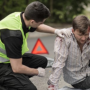 Injured pedestrian being taken care of by safety worker