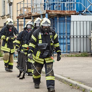 Firefighters carrying ladder to training