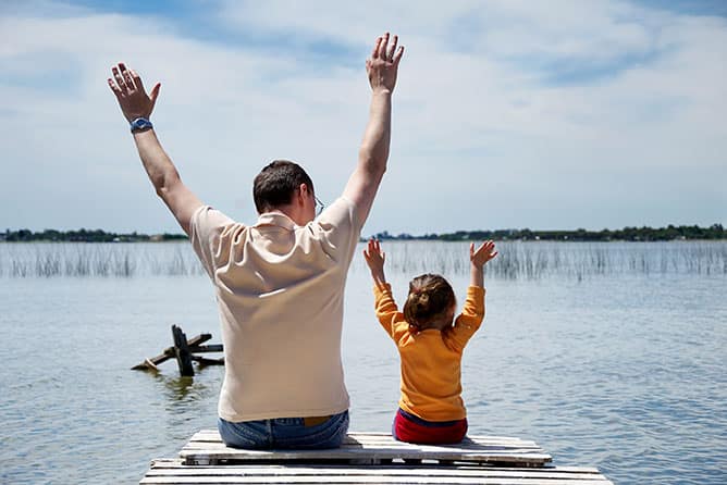 dad and daughter at a lake