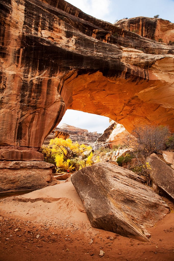 Autumn colors through red rock natural bridge.