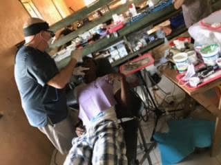 Dr. Gardner performing an oral exam during a trip to Honduras to help the Moskita people.