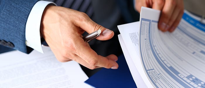 Patient reviewing and signing dental paperwork.