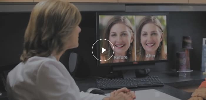 Dentist reviewing patient smile transformation on computer with before and after comparison, highlighting cosmetic dentistry results and smile makeover consultation.